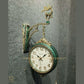 HDC Modern Double-Sided Wall Clock With a Decorative Clock has a Green Casing and a Deer-Shaped Ornament at the Top