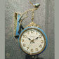 HDC Modern Double-Sided Wall Clock With a Decorative Light Blue Frame With Gold Accents, a Bird-Shaped Ornament on Top