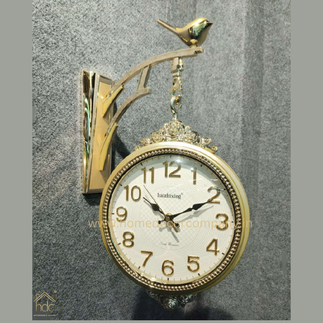 HDC Modern Double-Sided Wall Clock With a Decorative Golden Frame With Gold Accents, a Bird-Shaped Ornament on Top