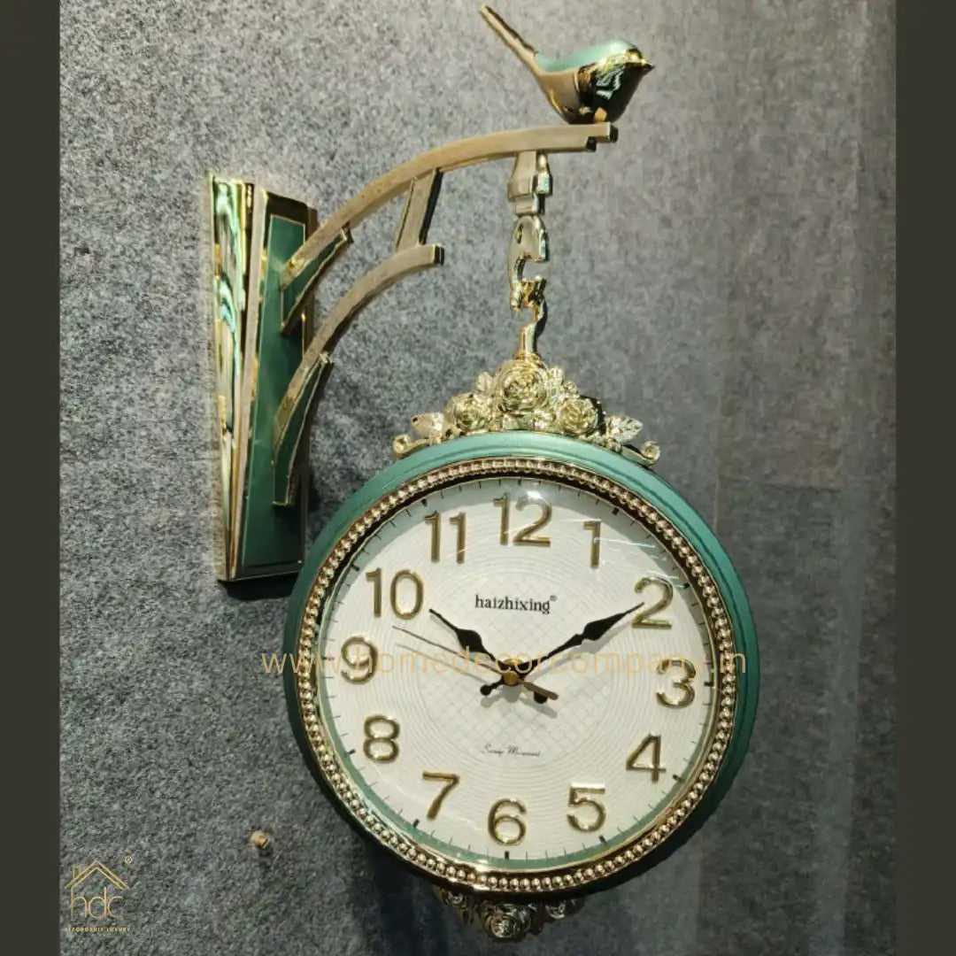 HDC Modern Double-Sided Wall Clock With a Vintage Design predominantly Green and Gold, a Bird-Shaped Ornament on Top