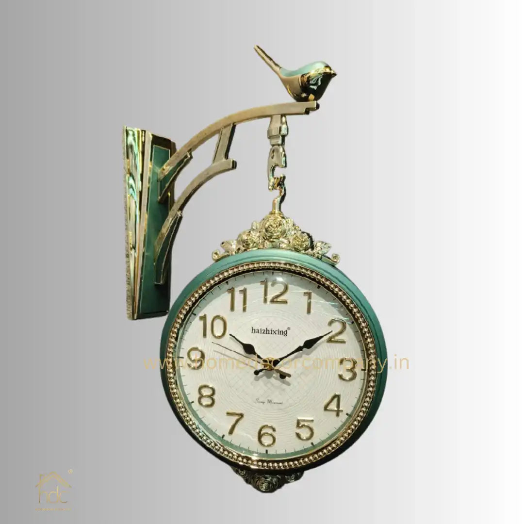 HDC Modern Double-Sided Wall Clock With a Vintage Design predominantly Green and Gold, a Bird-Shaped Ornament on Top