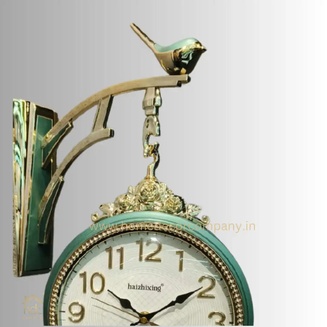 HDC Modern Double-Sided Wall Clock With a Vintage Design predominantly Green and Gold, a Bird-Shaped Ornament on Top