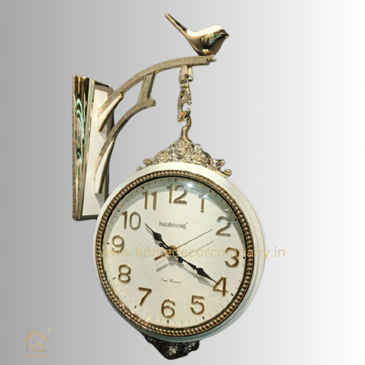 HDC Modern Double-Sided Wall Clock With a Vintage Design white clock face with black hands and gold-colored numerals, encased in a white frame with ornate gold detailing a Bird-Shaped Ornament on Top