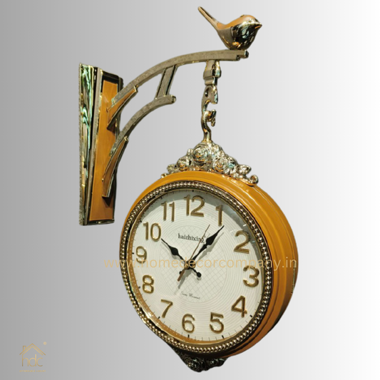 HDC Modern Double-Sided Wall Clock With a Retro Design Wooden clock face with black hands and gold-colored numerals, encased in a Wooden frame with gold detailing a Bird-Shaped Ornament on Top