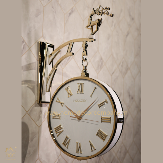 HDC Modern Double-Sided Vintage-Style Station Clock With a White Clock Face With Gold Roman Numerals and Hands, Encased in a White frame Decorative Deer Accent On the Top