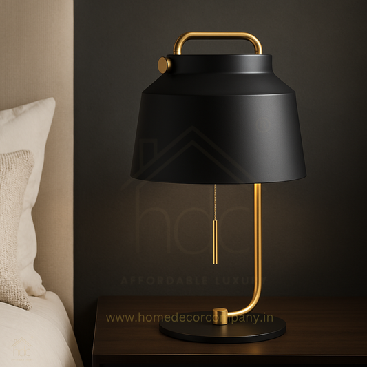 Black table lamp with gold accents on a wooden surface, brand 'Home Decor Company' visible.